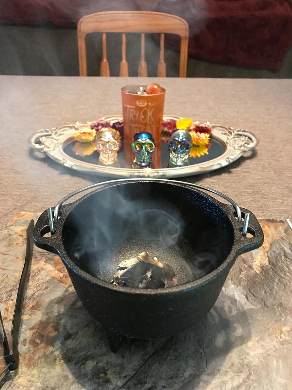 reviewer image of the backcountry iron cauldron being used to smoke sage on a living room table