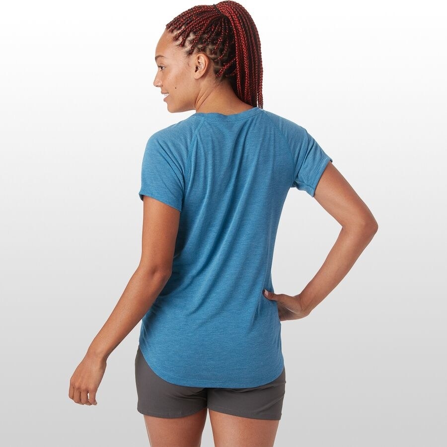 Model wears blue, lightweight T-shirt with loose black running shorts