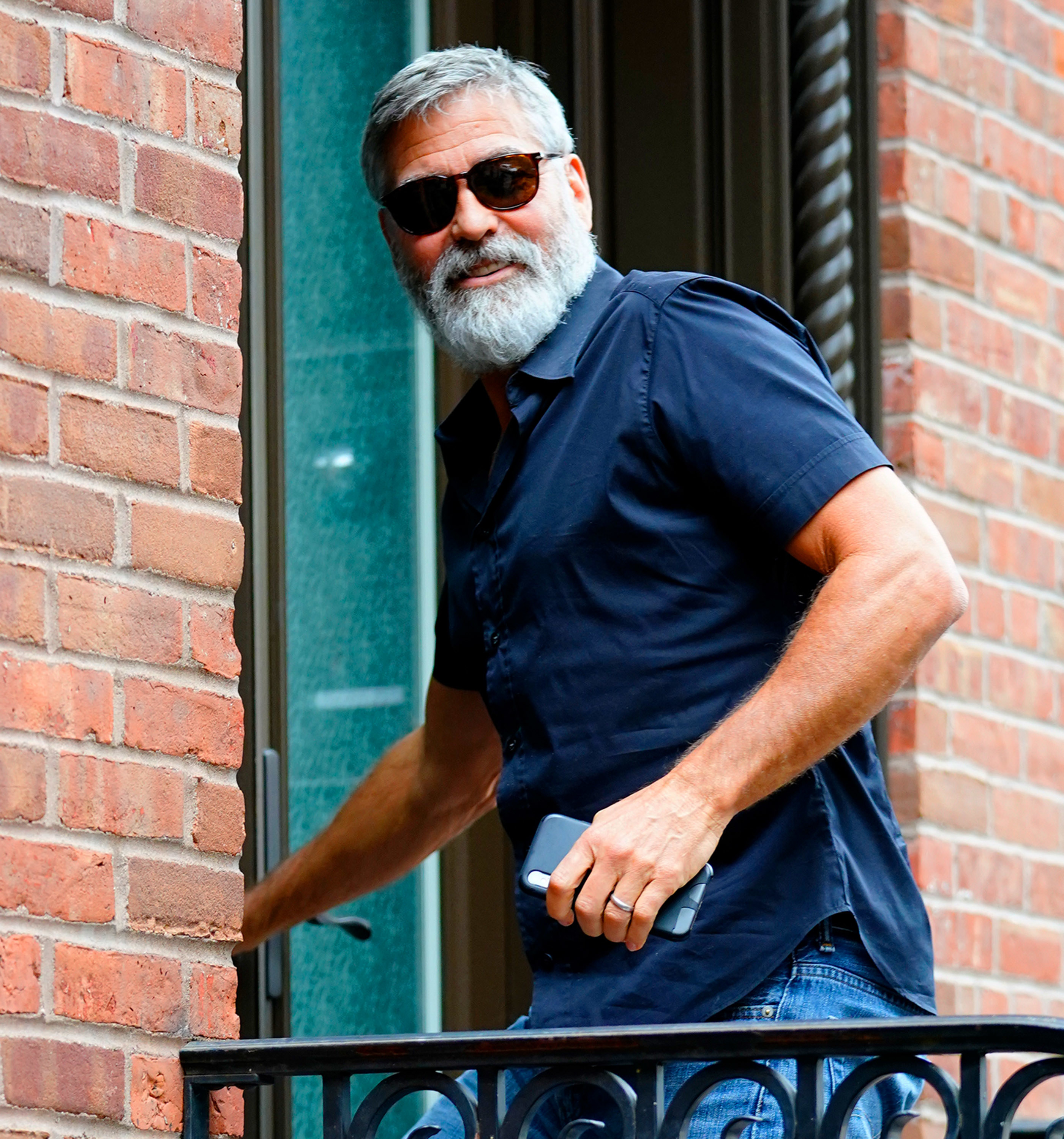 George Clooney entering a building