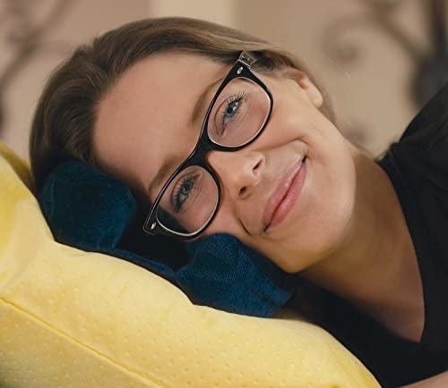 Model lying on their side on the pillow while wearing glasses
