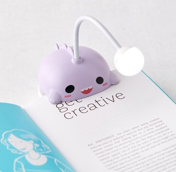 the purple angelfish light clipped to a book 