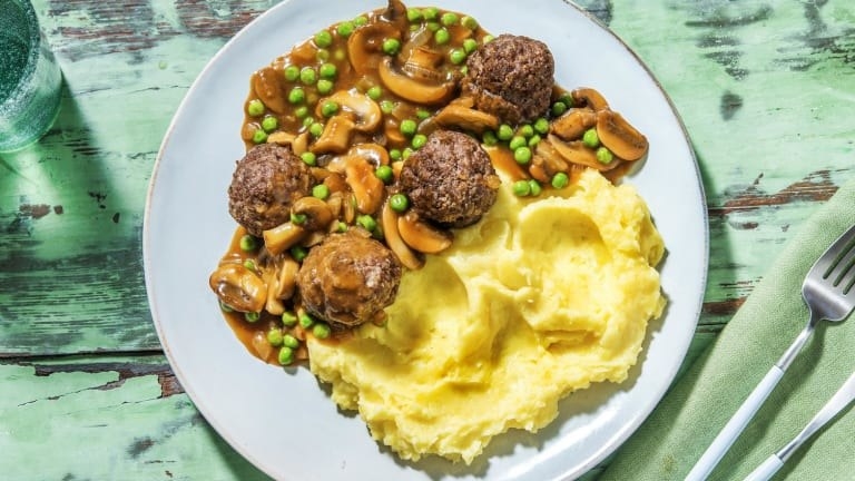 Salisbury steak potatoes with mushrooms and peas in gravy and smashed potatoes