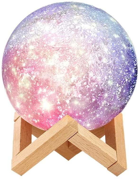 Pink, purple, and white moon lamp on wooden stand