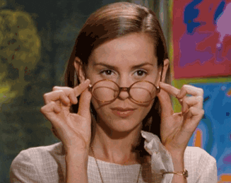 Miss Honey from Matilda taking off her glasses in delight