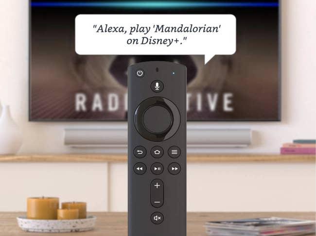 A slim black remote control with small buttons, including one that you can talk into 
