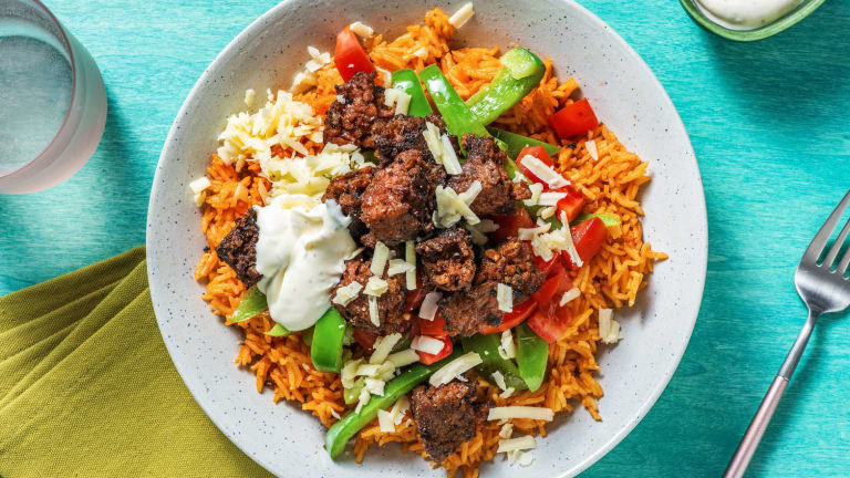 The Mexican spiced veggie bowl with rice, beyond meat, veggies, and crema