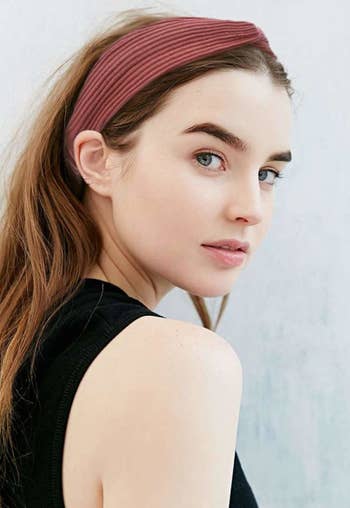 Model wearing red knotted headband
