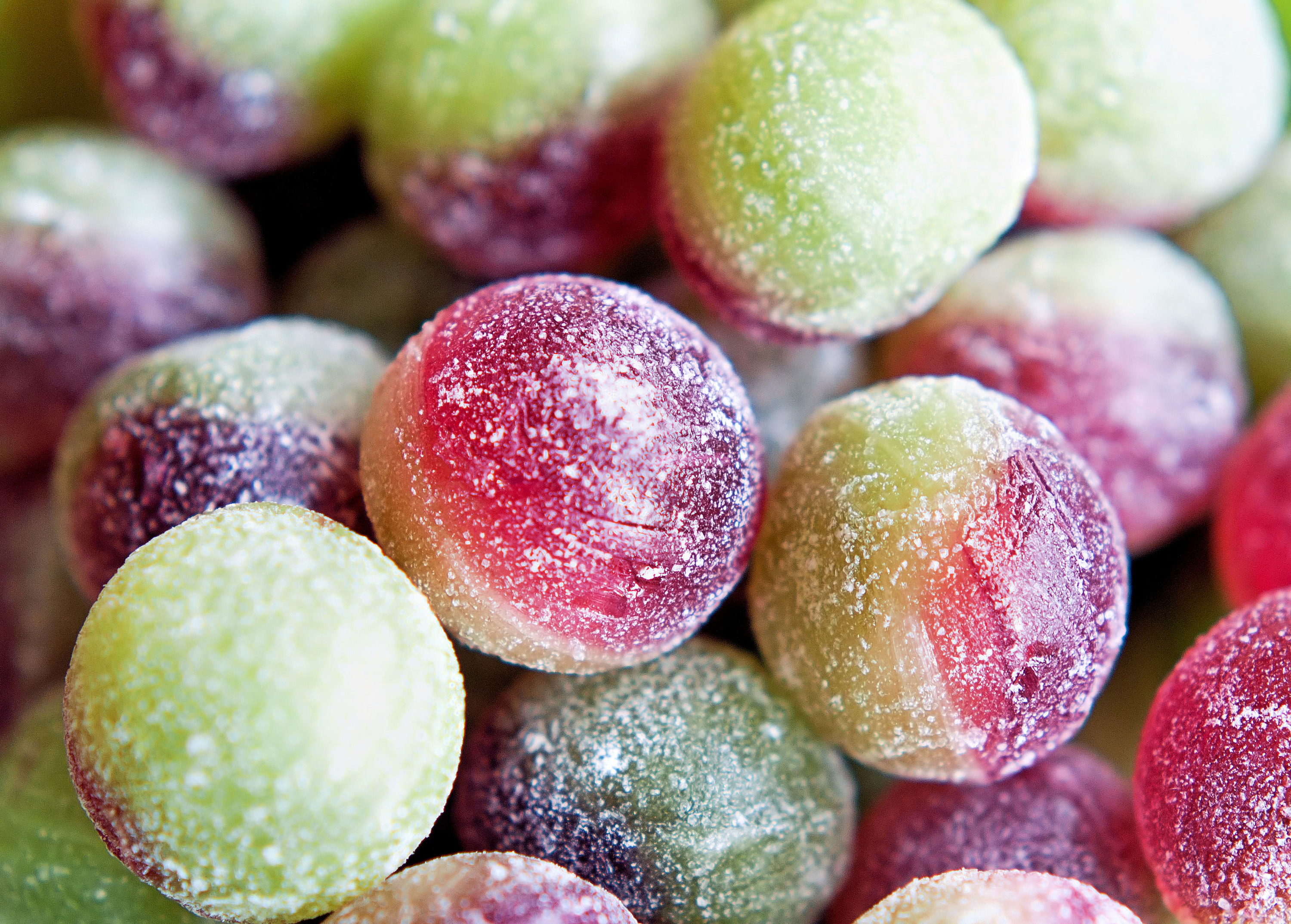 Colorful red and green hard candies covered in sugar. 