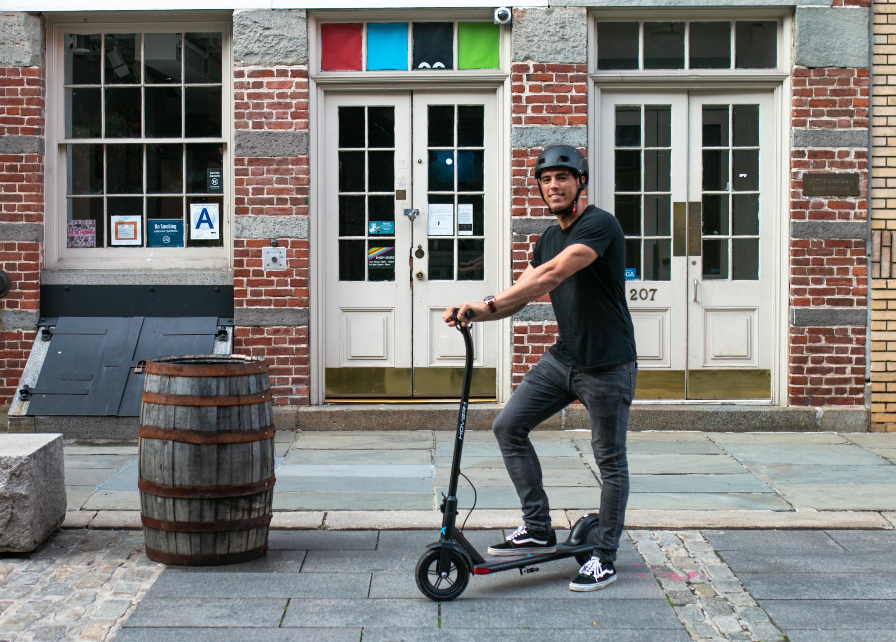 person posing with one foot on an electric scooter