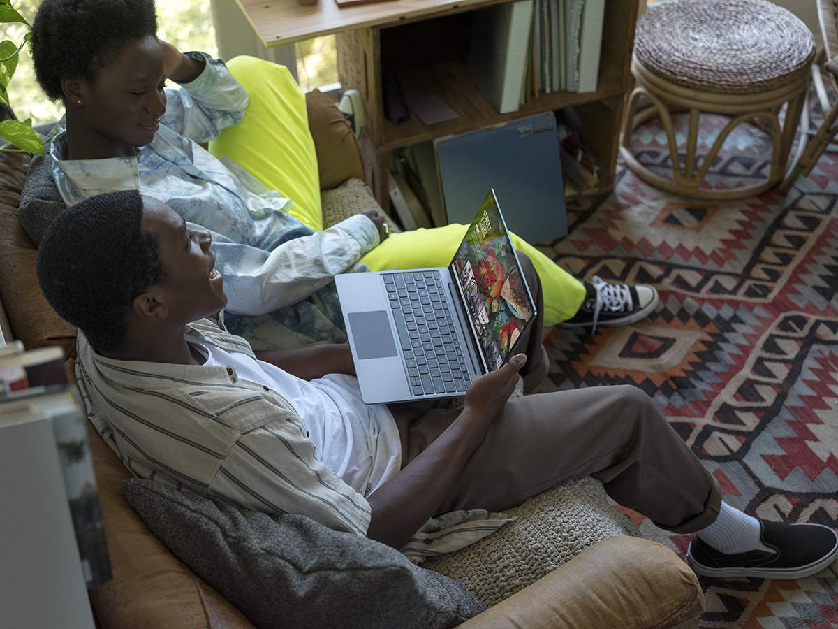 Two people using Netflix on the Microsoft laptop