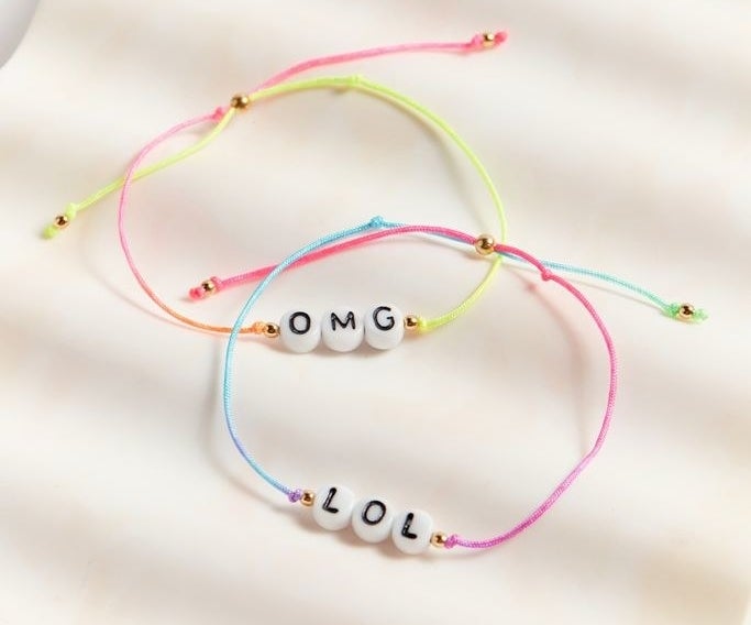 the OMG/LOL bracelets with multi-color bands and a gold clasp to seal 