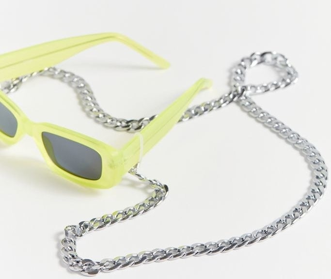 the silver sunglasses chain attached to a yellow pair of sunglasses