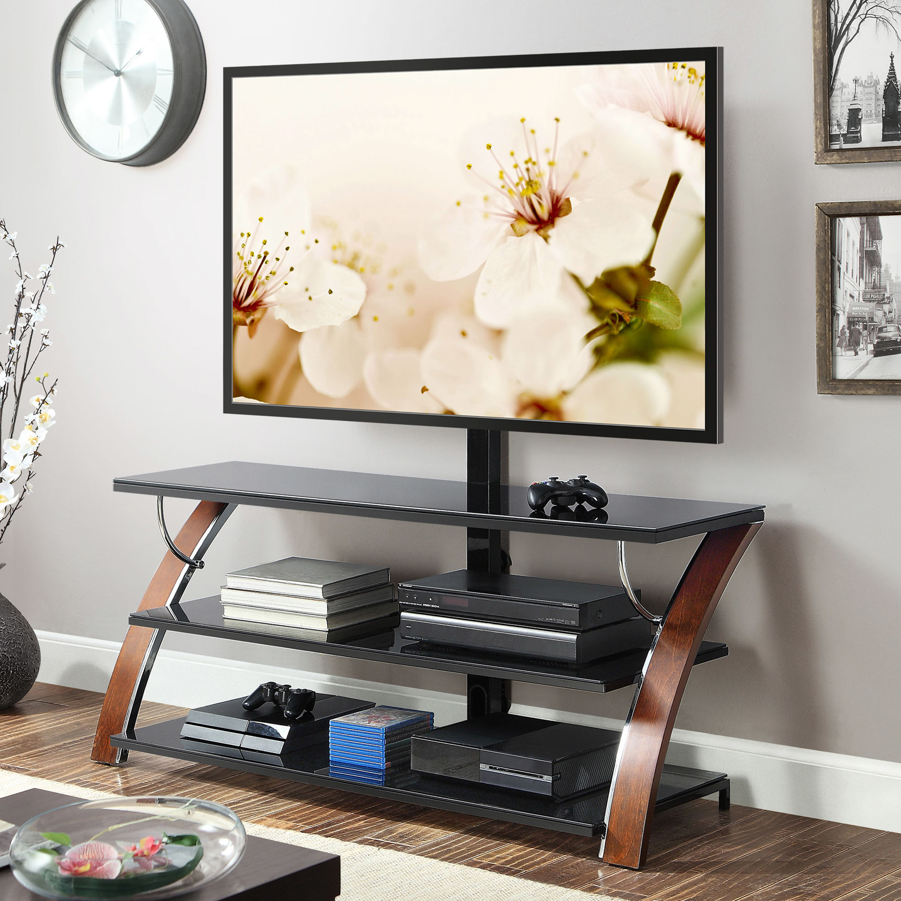 black three tier tv stand with a flat screen tv on top