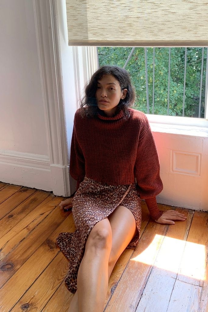a girl wearing the distressed turtleneck in red
