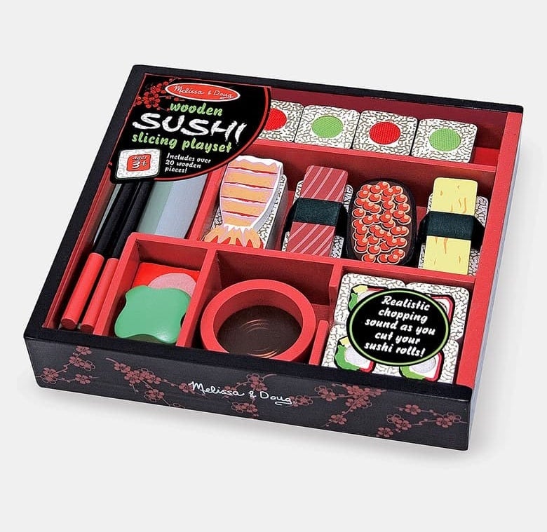 A box filled with all the wooden toys that look like sushi