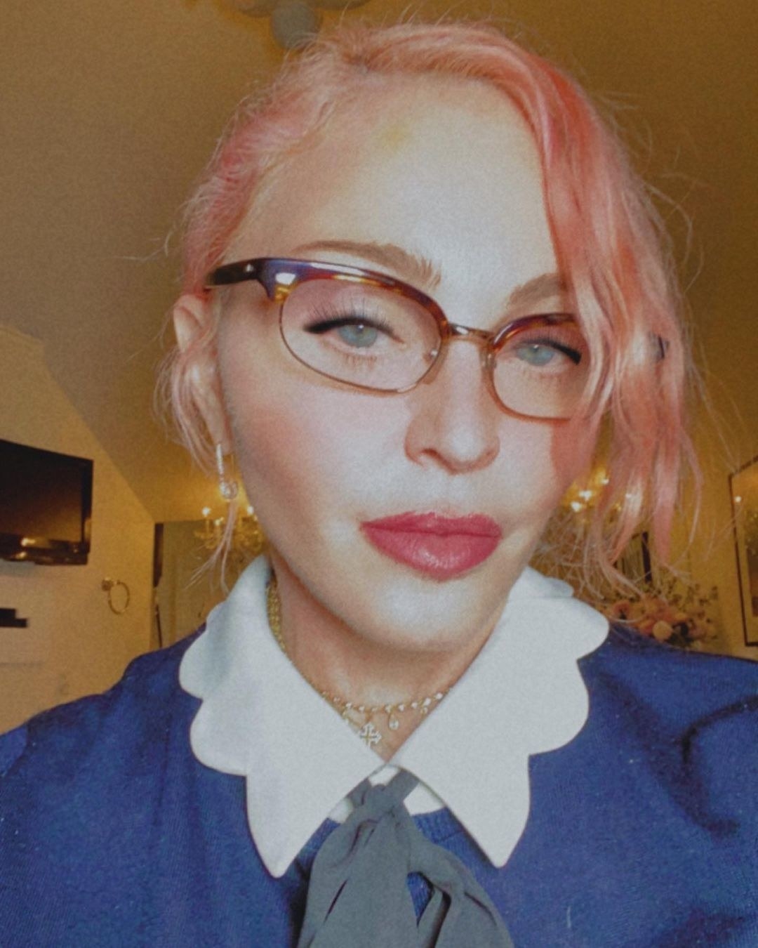 Madonna taking a selfie in quarantine while wearing glasses and pink hair