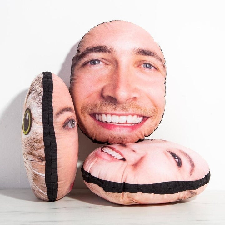 A pile of pillows personalized with people's faces