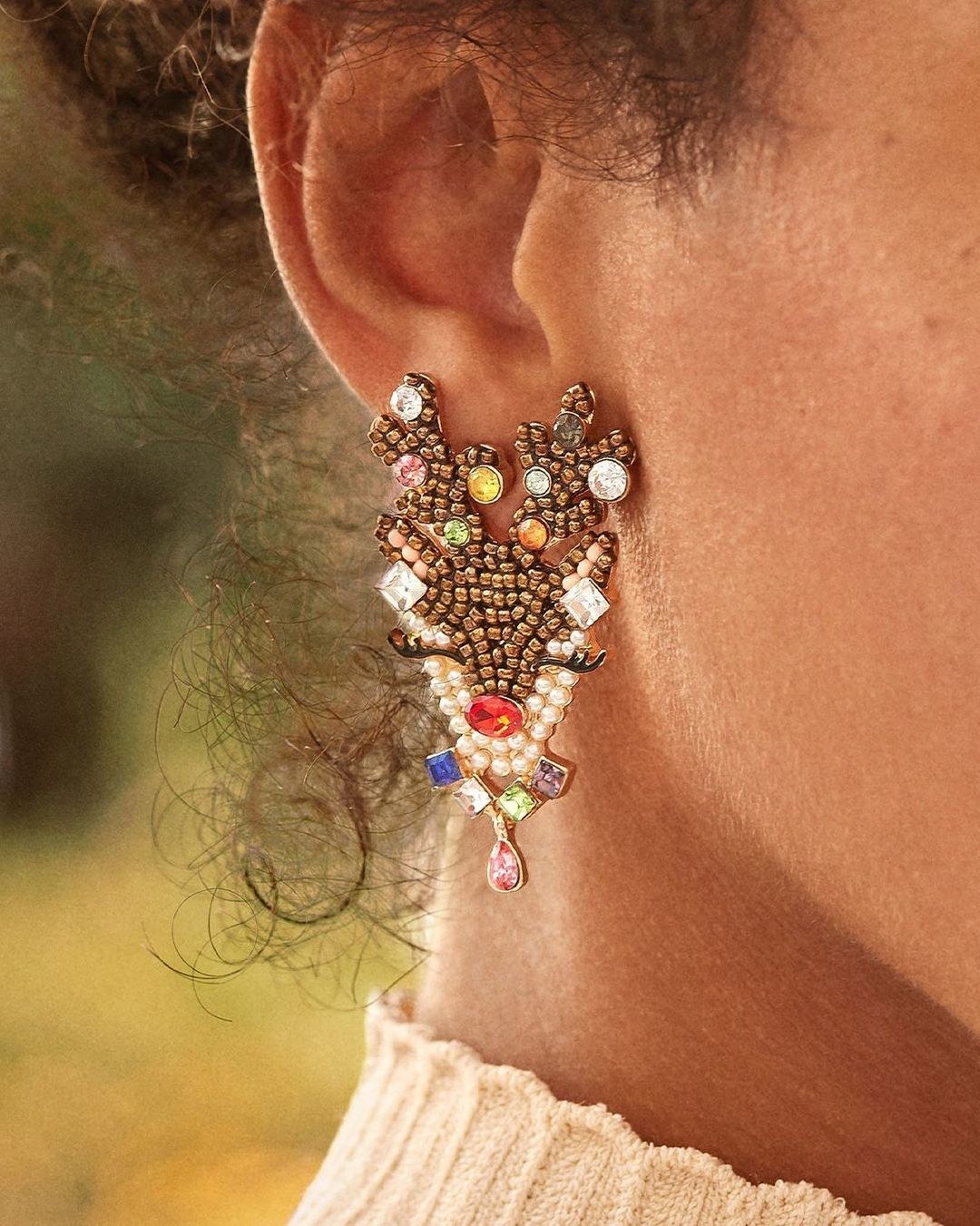 model wearing the reindeer-inspired earrings