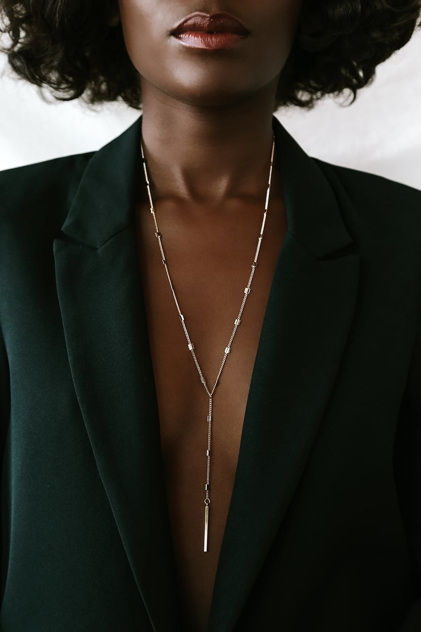 model wearing the long gold necklace
