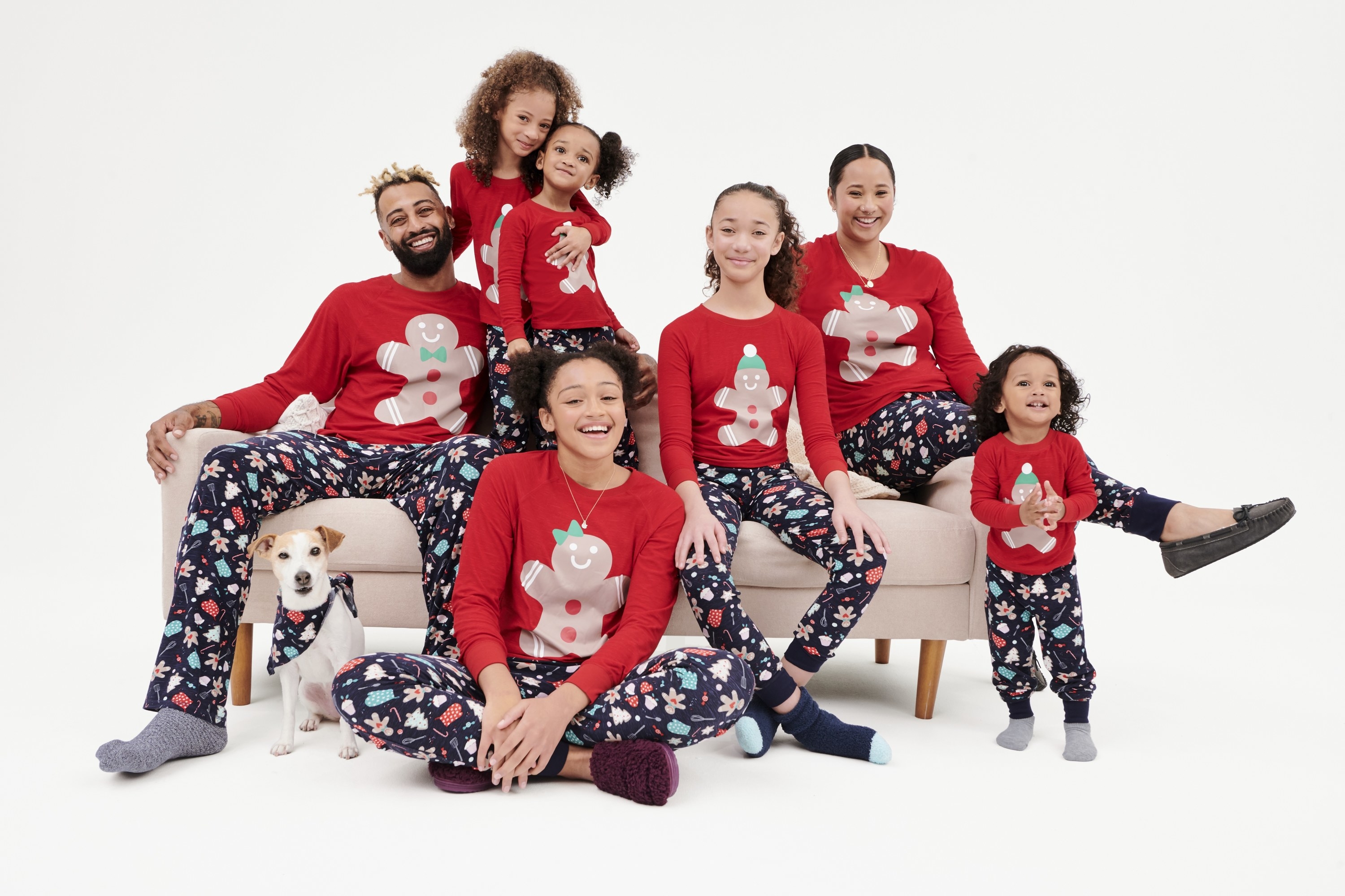 parents, children of all ages, and a dog in matching pajamas with gingerbread men on them