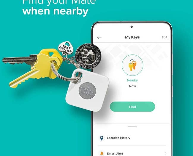 A Tile on a key ring with keys next to a phone displaying the app