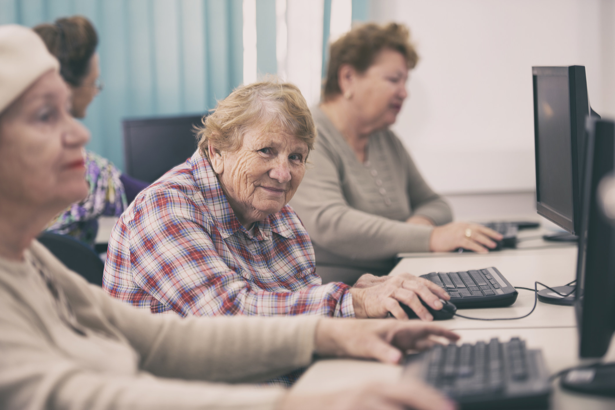 old lady at a computer smiling