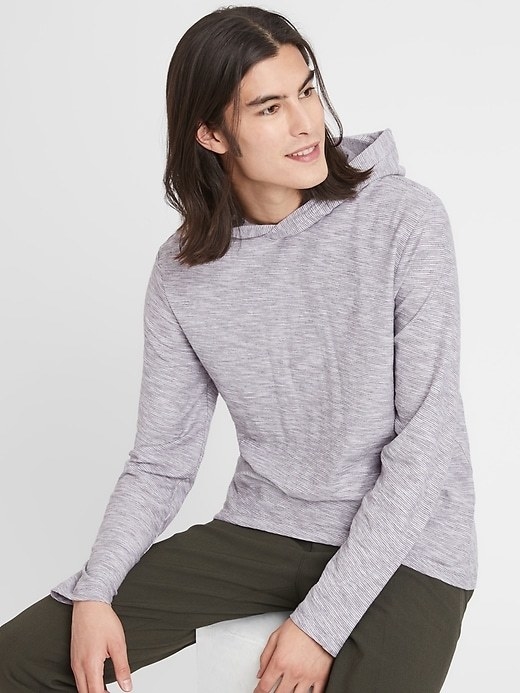 A model wearing a vintage hoodie in white and grey striped