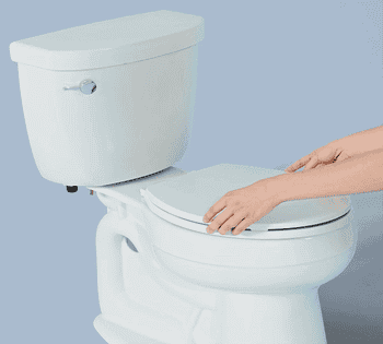 A Gif of a Tushy bidet being installed on a toilet and squirting water when the knob is twisted 