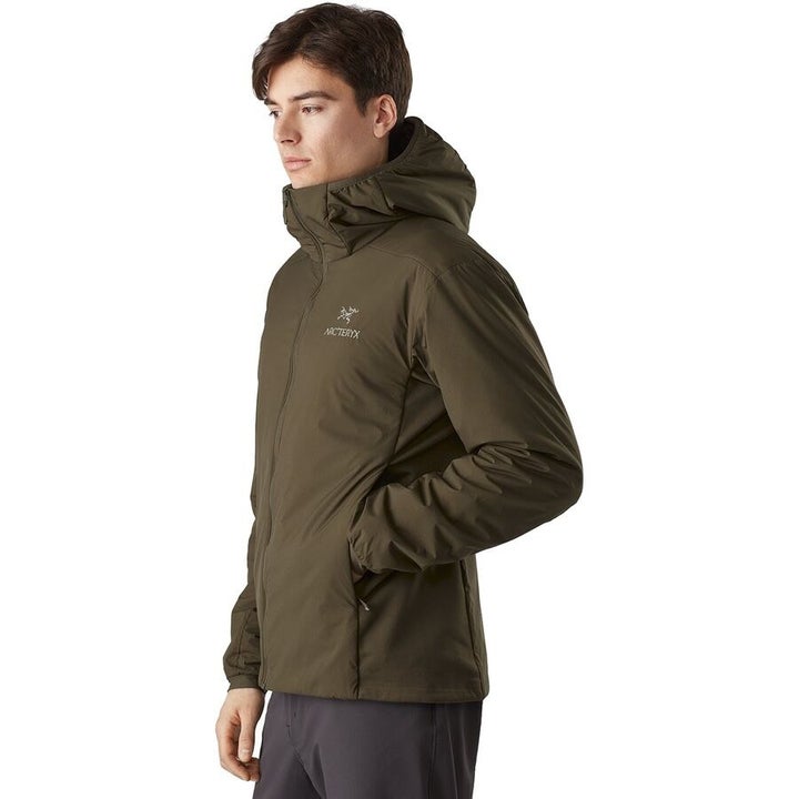 model in an olive Arcteryx hooded jacket