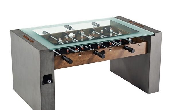 gray and wood foosball table with glass tabletop