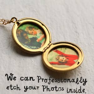 the locket open with two photos inside