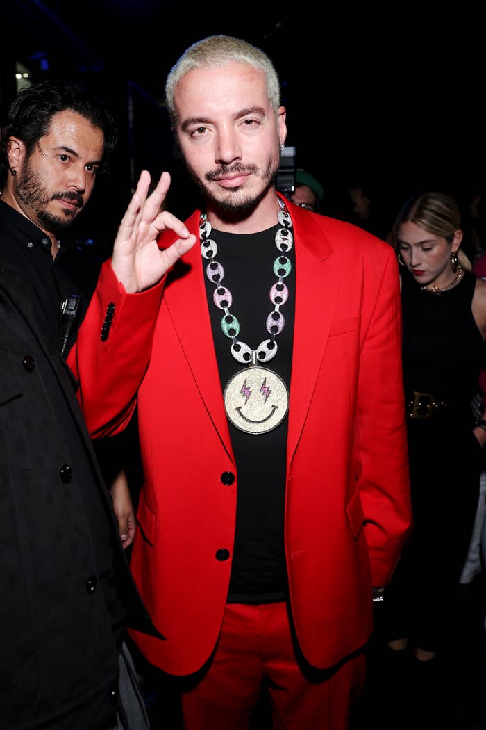 J Balvin wearing a suit and a large chain attends the 2020 Spotify Awards