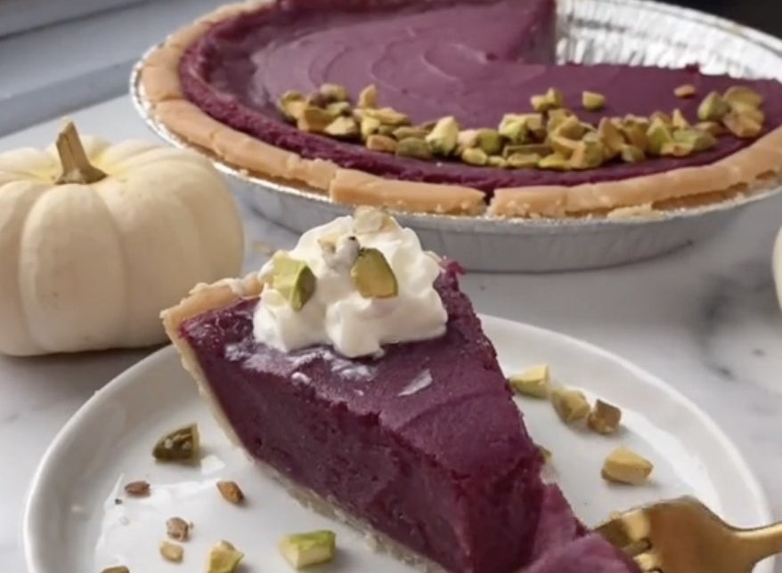 A purple pie with whipped cream