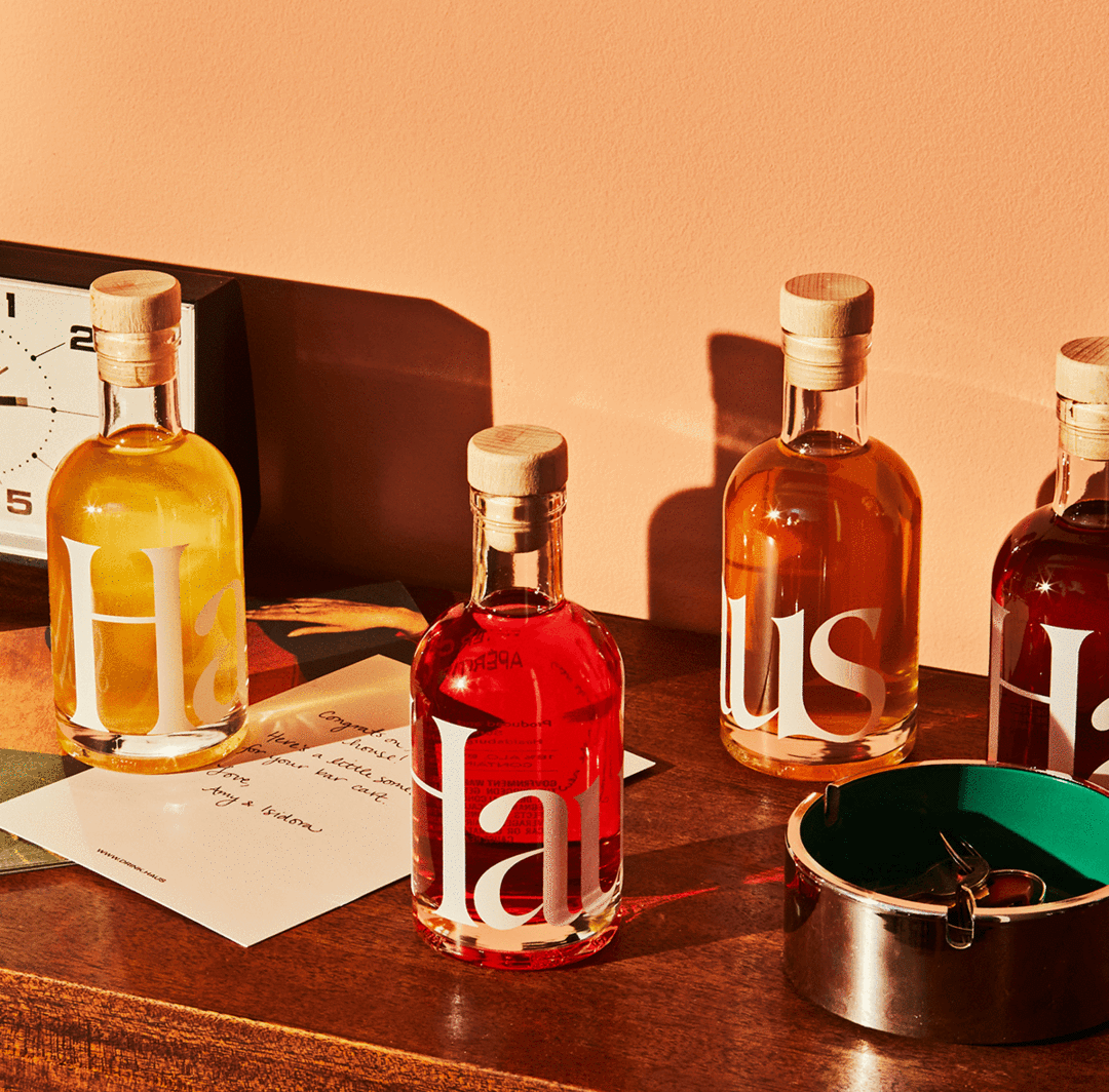 Four bottles of Haus styled on a table