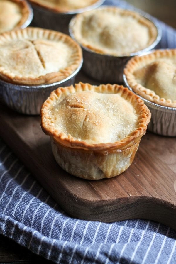 Mini apple pies cooked in cupcake holders. 