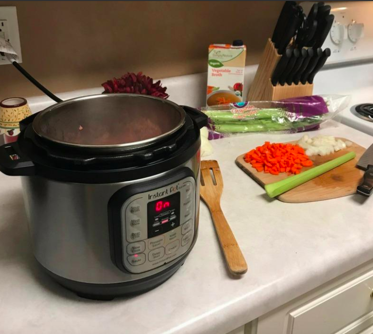 Reviewer photo showing Instant Pot on kitchen countertop next to a cutting board with chopped vegetables on it 
