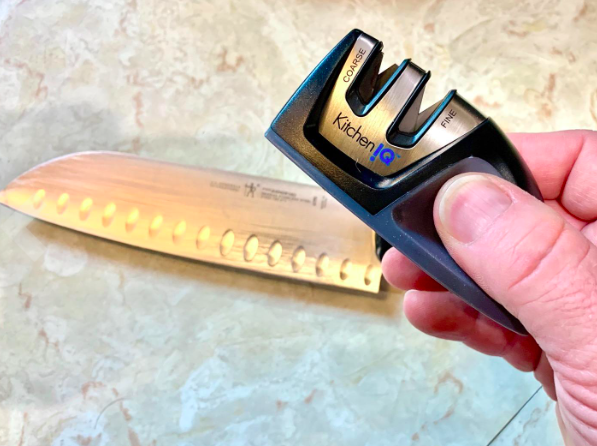 Reviewer photo showing knife sharpener next to a kitchen knife 