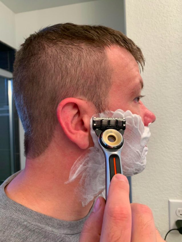 Reviewer shaving with the heated razor 