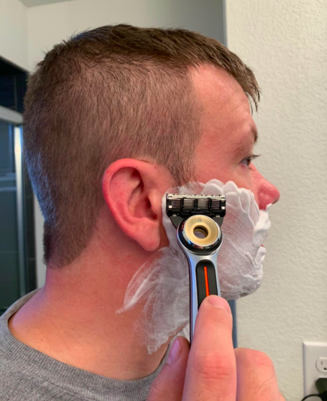Reviewer shaving with the heated razor 