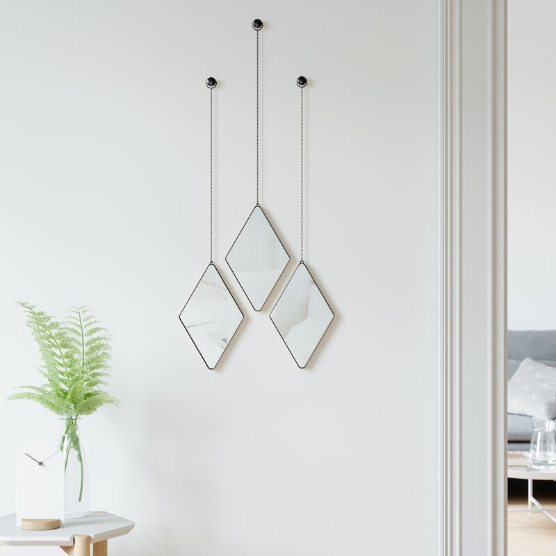 Three hanging mirrors