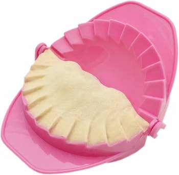 a pink hand pie press with dough inside