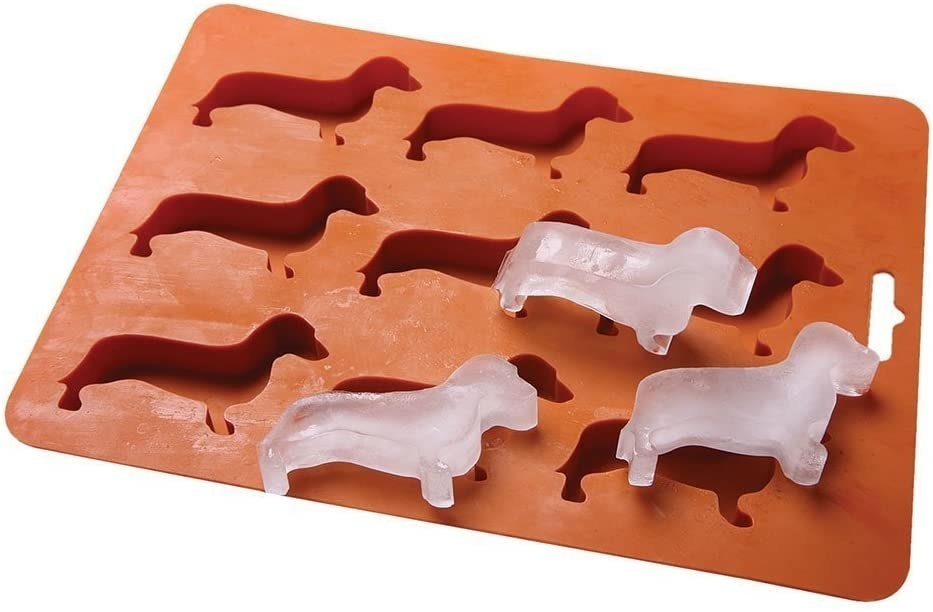 Three dachshund-shaped ice cubes on top of an ice tray