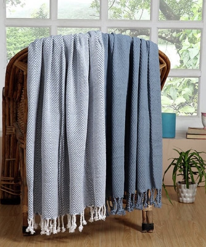 two blue cozy throw blankets over a chair 
