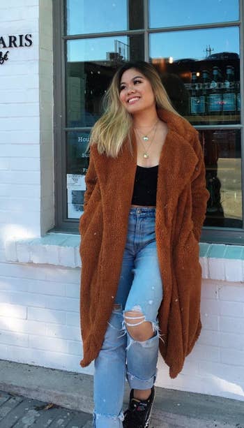 reviewer wearing the coat in caramel
