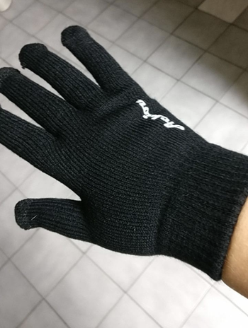 Same reviewer showing plain black of back side of glove 