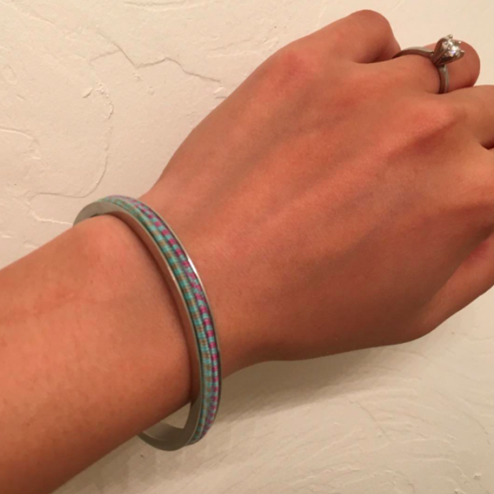 Reviewer photo showing the hair tie bracelet on a wrist with two hair ties placed around the bracelet 