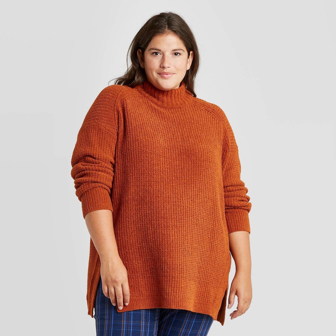 Model wearing orange sweater