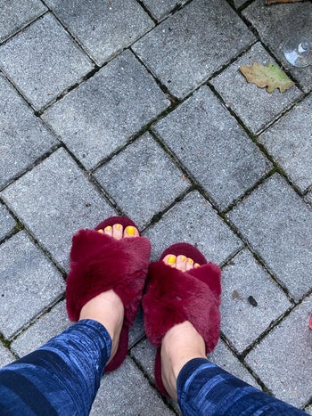 A different reviewer wearing the slippers in burgundy