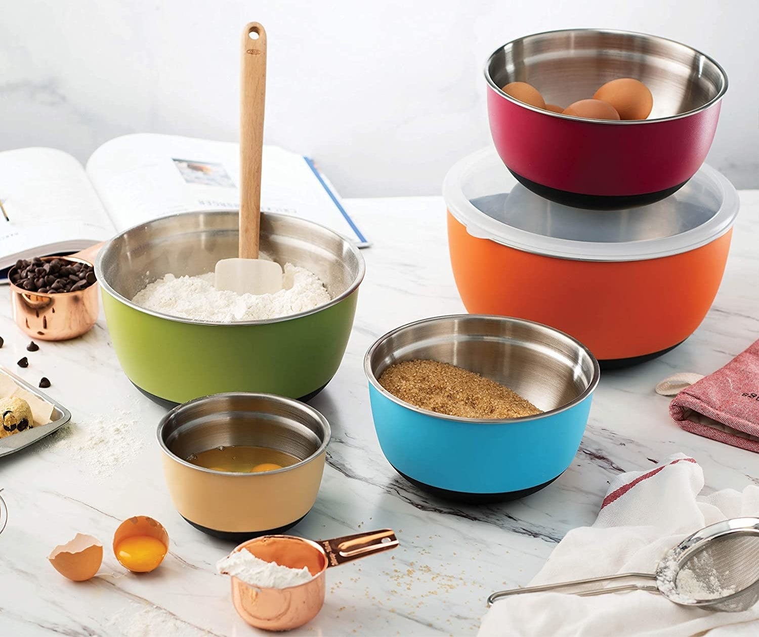 Five stainless steel bowls with different baking ingredients in them