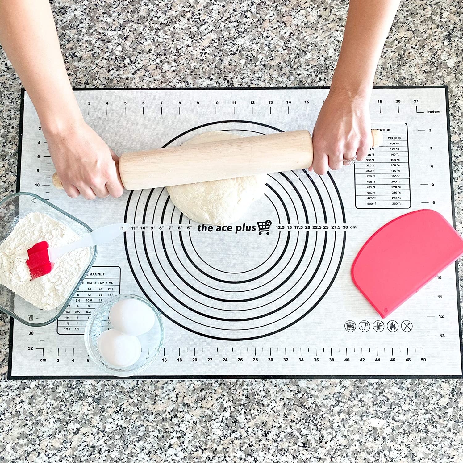 A person rolling out dough on a silicone baking mat